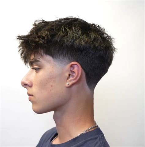 Short Messy Top with Fringe and Low Tape Up. A low tape up with a short messy top and fringe is a balanced, versatile and classy hairstyle that can work for teen boys and young men. the best of both worlds. The textured volume on top draws focus to the bangs while the taper provides fashionable contrast.